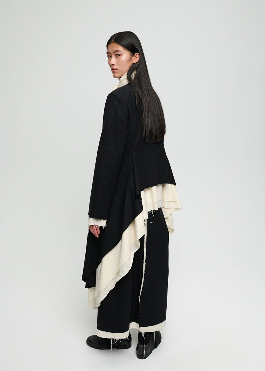 Black skirt with white trim worn by a person on a white background