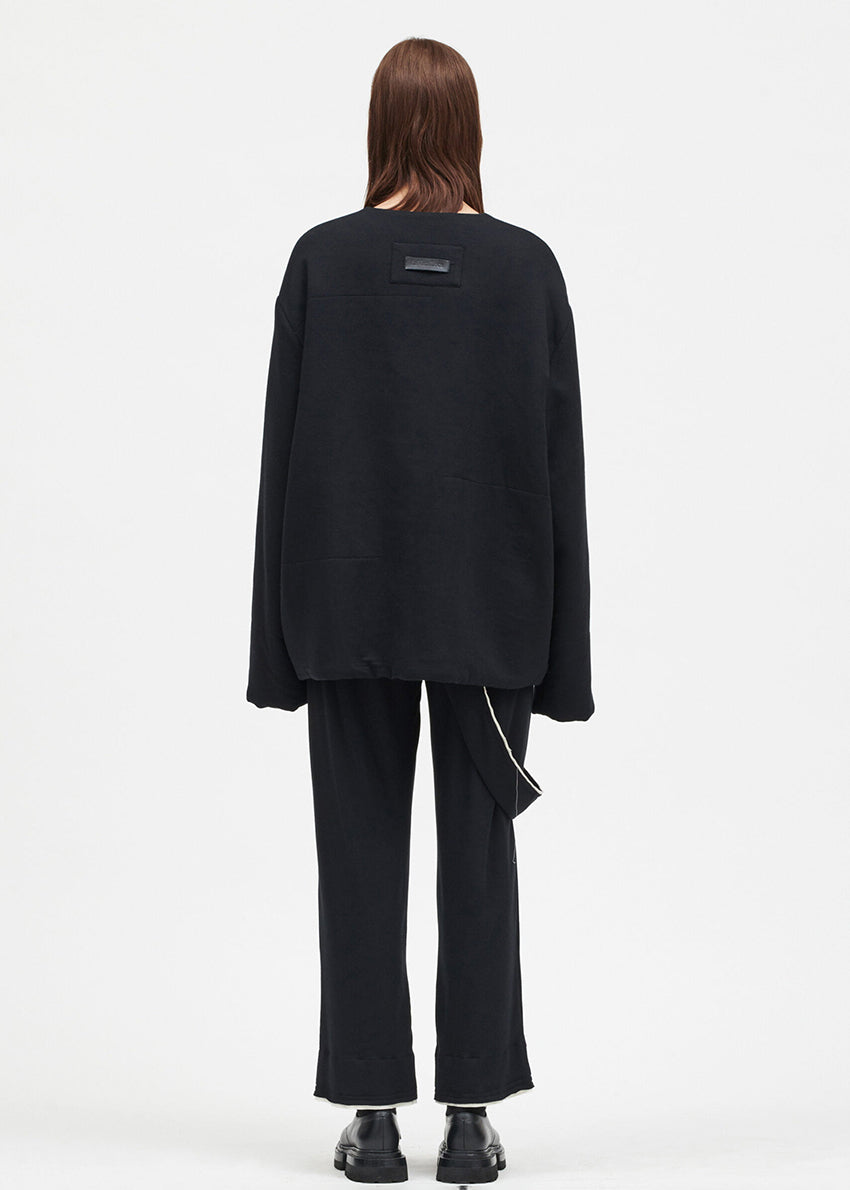 A short unisex black jacket with a front zip and two front pockets, made from soft elastic micromodal fabric.