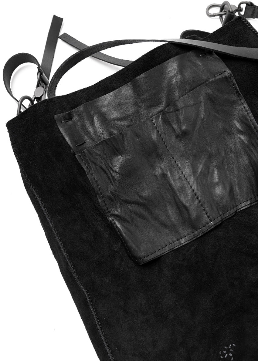 Black leather bag with straps on a white background