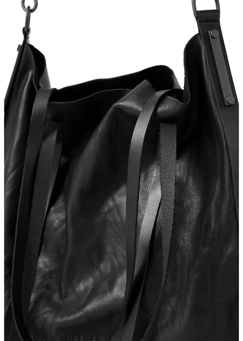 Black leather bag with straps on a white background
