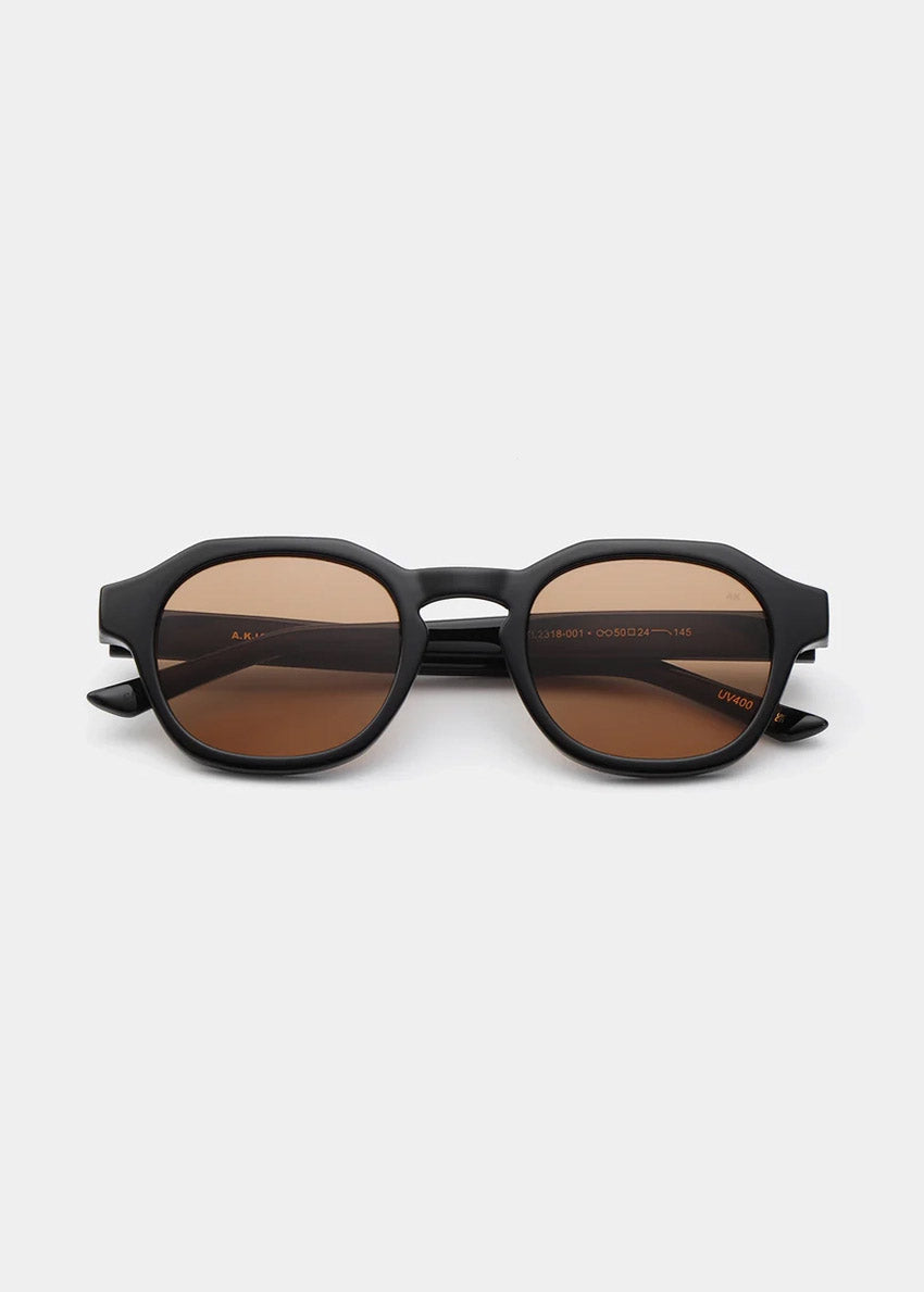 Round sunglasses with brown lenses on a white background