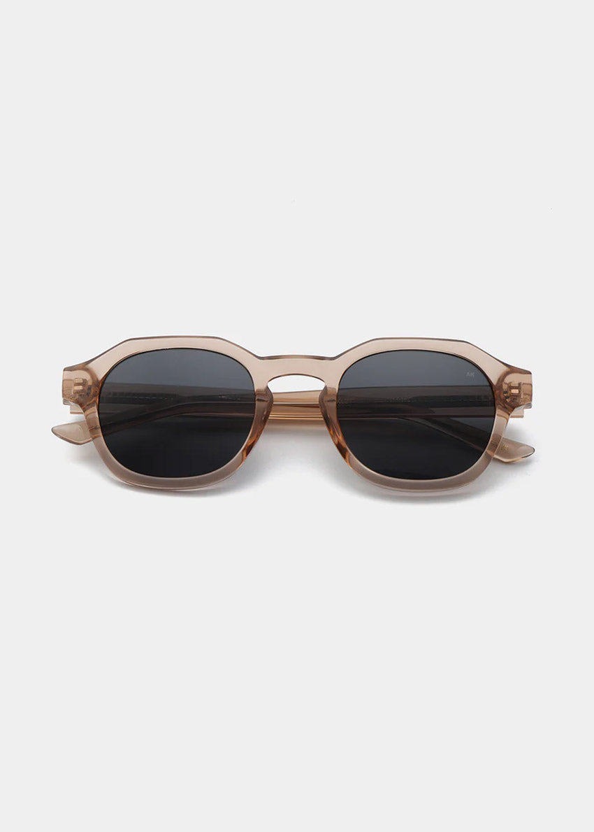 Sunglasses with a tortoiseshell frame and dark lenses on a white background
