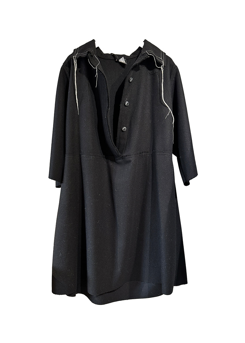 The La vaca Loca Midi dress features 3/4 sleeves, a shirt neckline with a button closure, and a loose baby doll fit. Its unfinished trims add a touch of understated sophistication, while the deep V neckline adds a hint of elegance.