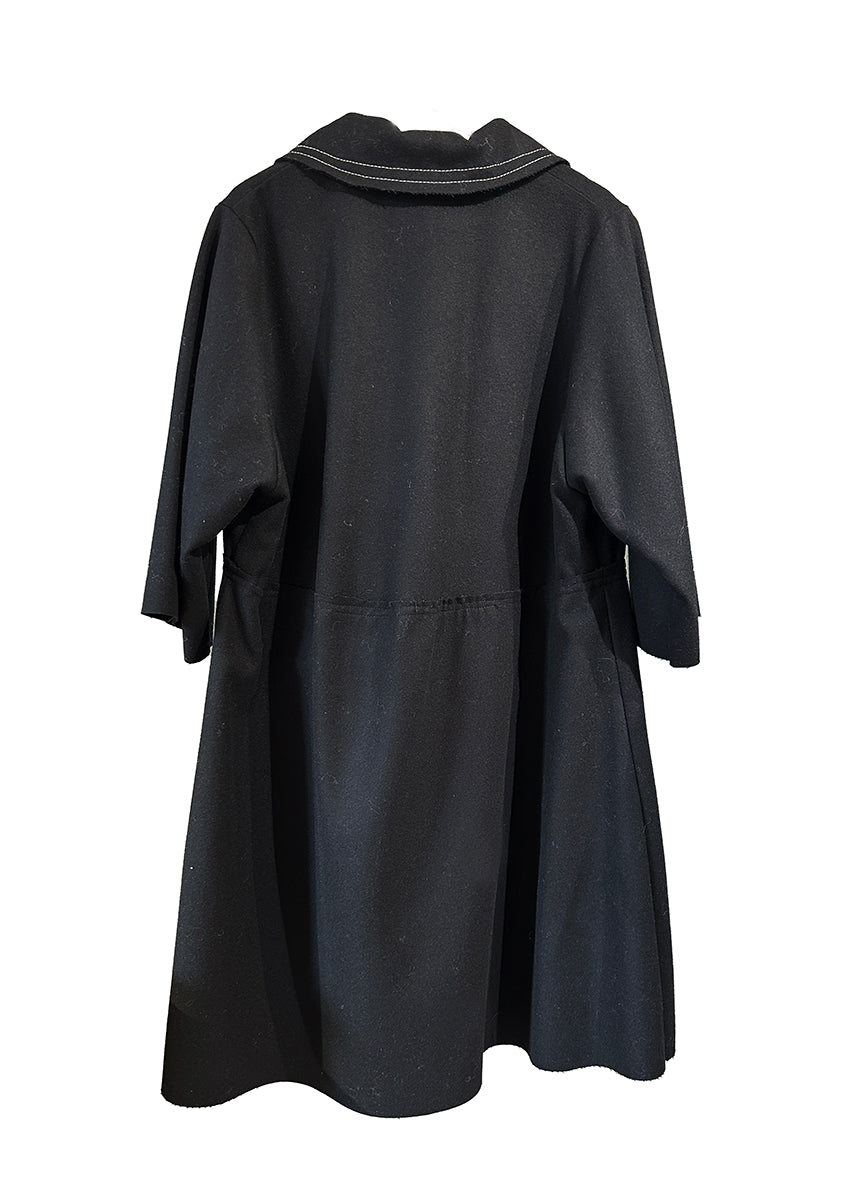 The La vaca Loca Midi dress features 3/4 sleeves, a shirt neckline with a button closure, and a loose baby doll fit. Its unfinished trims add a touch of understated sophistication, while the deep V neckline adds a hint of elegance.