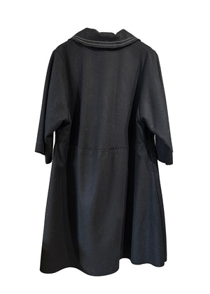 The La vaca Loca Midi dress features 3/4 sleeves, a shirt neckline with a button closure, and a loose baby doll fit. Its unfinished trims add a touch of understated sophistication, while the deep V neckline adds a hint of elegance.