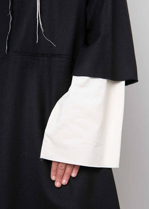 The La vaca Loca Midi dress features 3/4 sleeves, a shirt neckline with a button closure, and a loose baby doll fit. Its unfinished trims add a touch of understated sophistication, while the deep V neckline adds a hint of elegance.