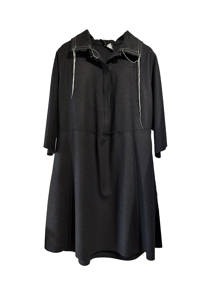 The La vaca Loca Midi dress features 3/4 sleeves, a shirt neckline with a button closure, and a loose baby doll fit. Its unfinished trims add a touch of understated sophistication, while the deep V neckline adds a hint of elegance.