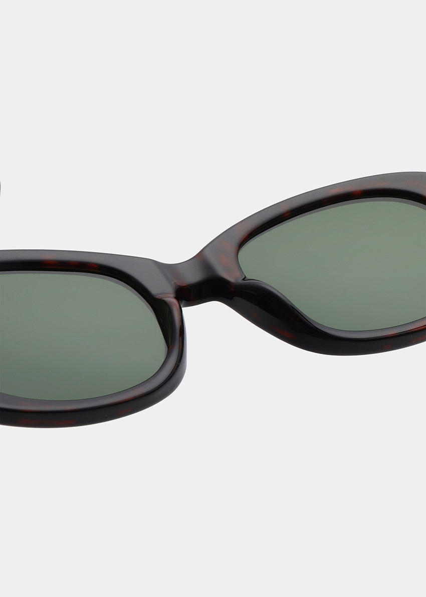 Sunglasses with dark frame and green lenses on a white background