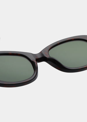 Sunglasses with dark frame and green lenses on a white background