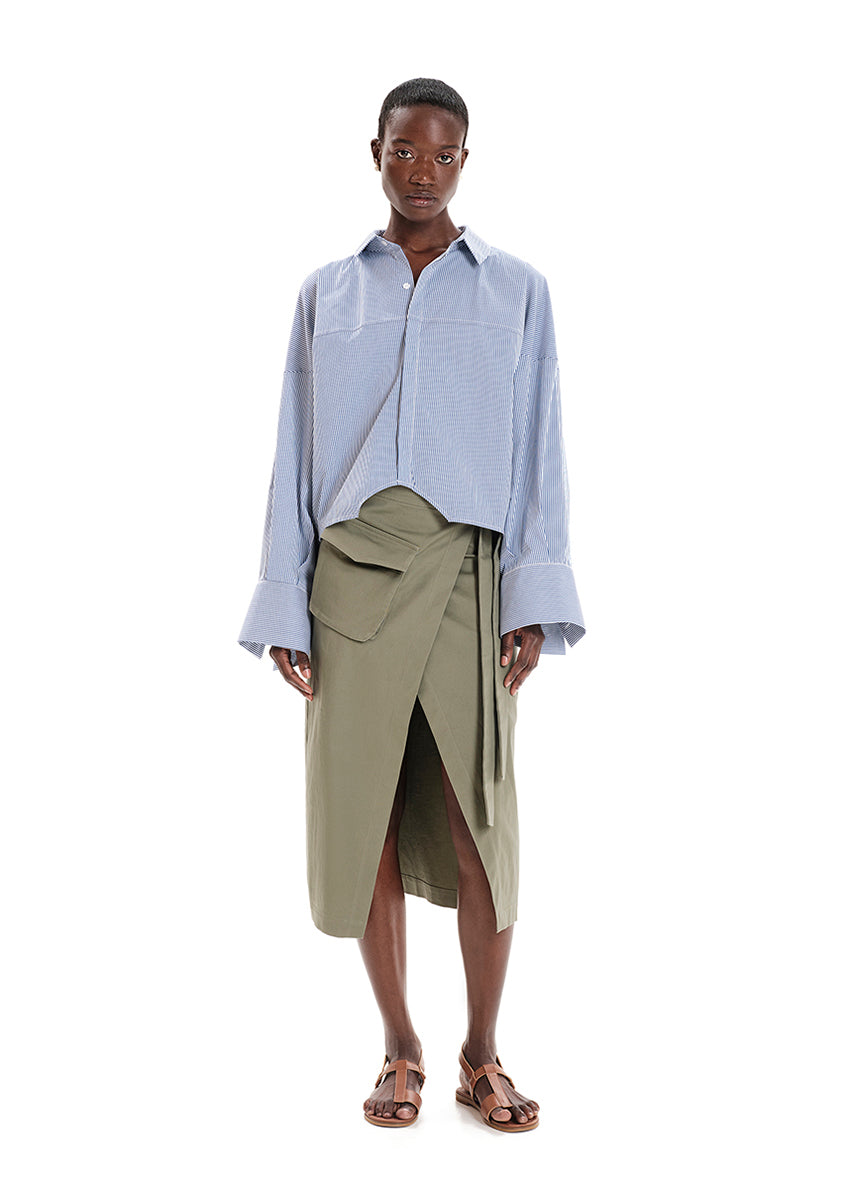 Made with durable, high-quality cotton fabric, this skirt is designed with a unique wrap-style and boasts a large pocket and generous front slit. Perfect for everyday wear!