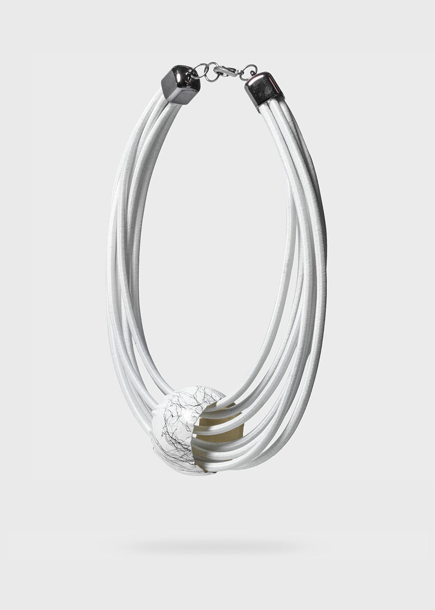 A white, multi-layered choker necklace with a cylindrical pendant and dimgray details, designed by Katerina Vassou.