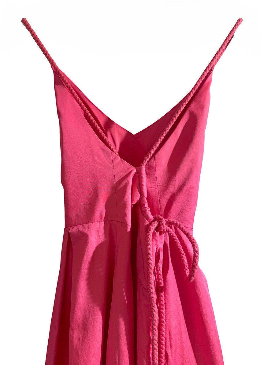 Pink dress with thin straps on a white background