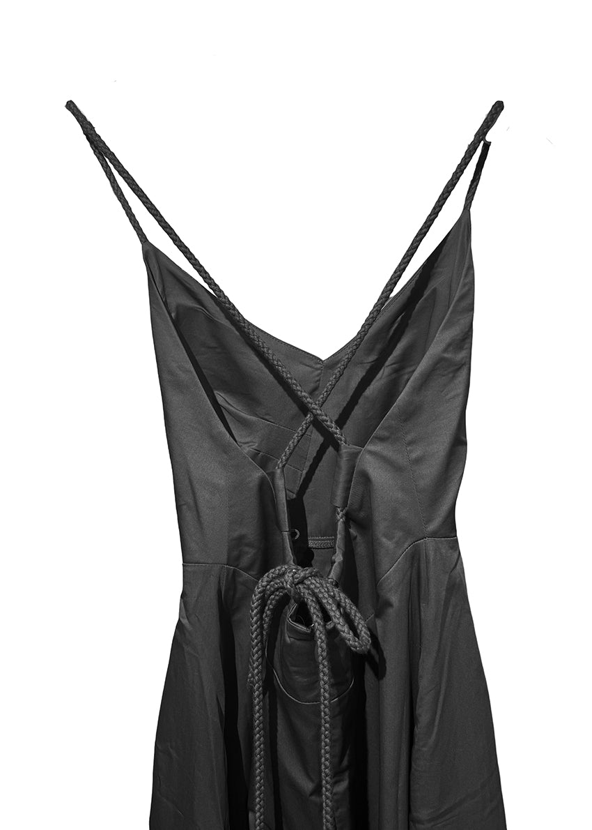 Midi asymmetrical dress made of 100% silky touch cotton poplin that features a “V” neck and open back. With a cinched waist and a figure-hugging pattern at the bust it has details with ropes that tie at the back creating an “X” shape. It has a concealed zipper and side pockets while it also has a button inside the skirt to create an asymmetry at the hemline.