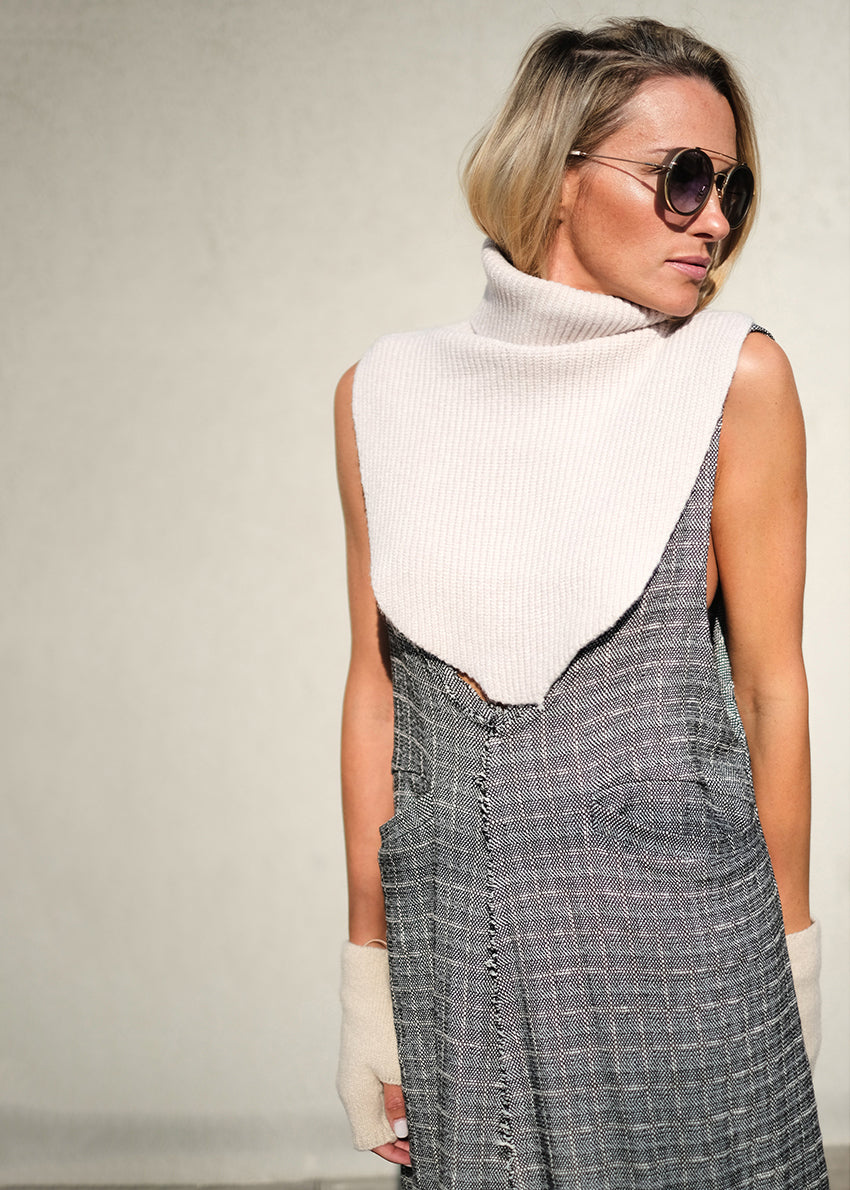 A white, ribbed, knitted neck collar