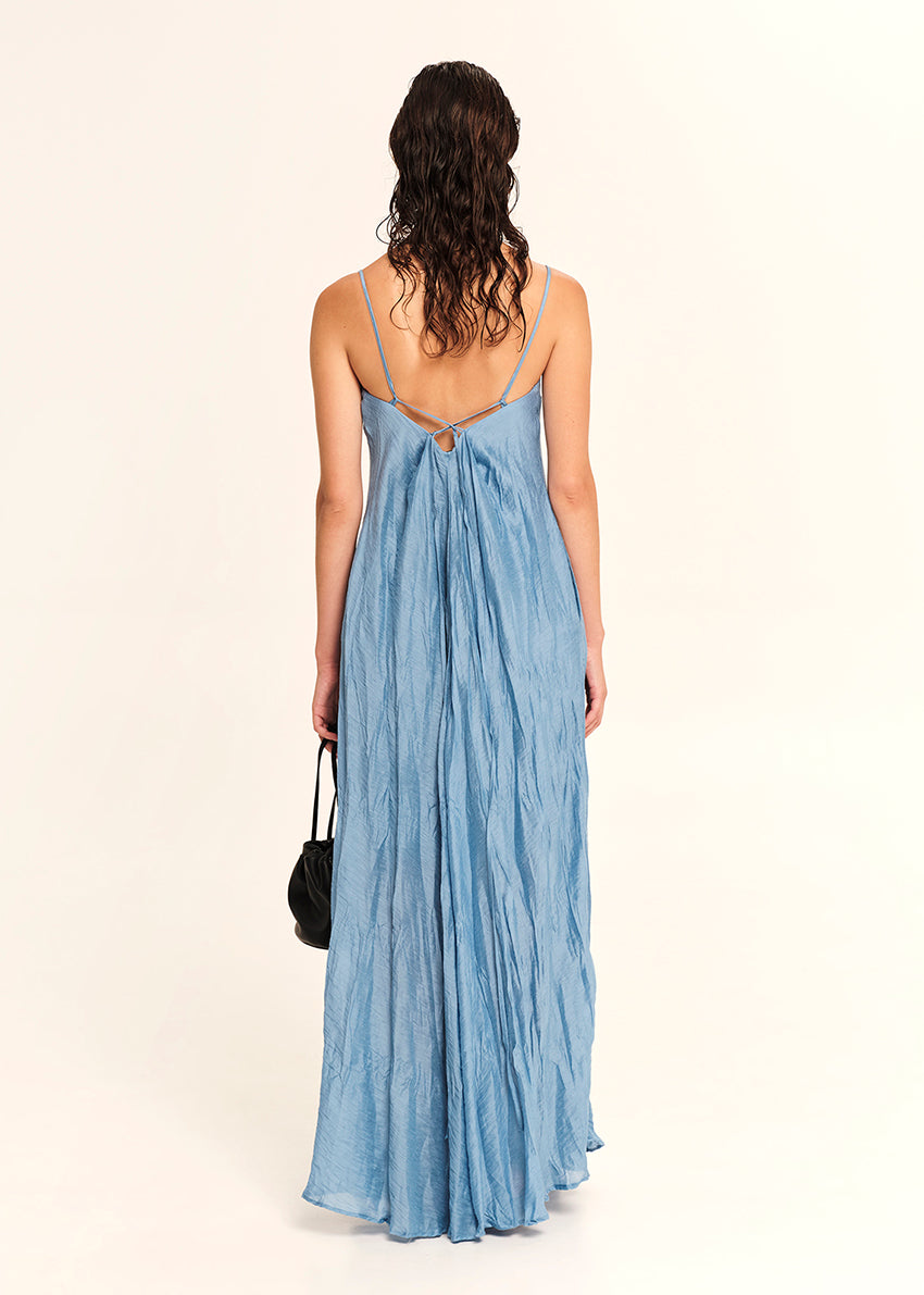 Woman wearing a blue dress with a white background