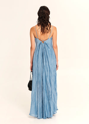 Woman wearing a blue dress with a white background