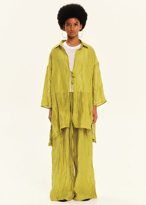 Person wearing a green outfit on a white background