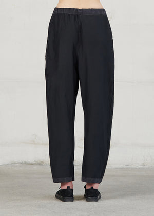 Black pants worn by a person on a plain background