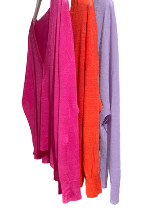 Orange, deep pink and thistle linen pullover sweaters with a deep V-neck and dropped sleeves, with visible textured fabric.