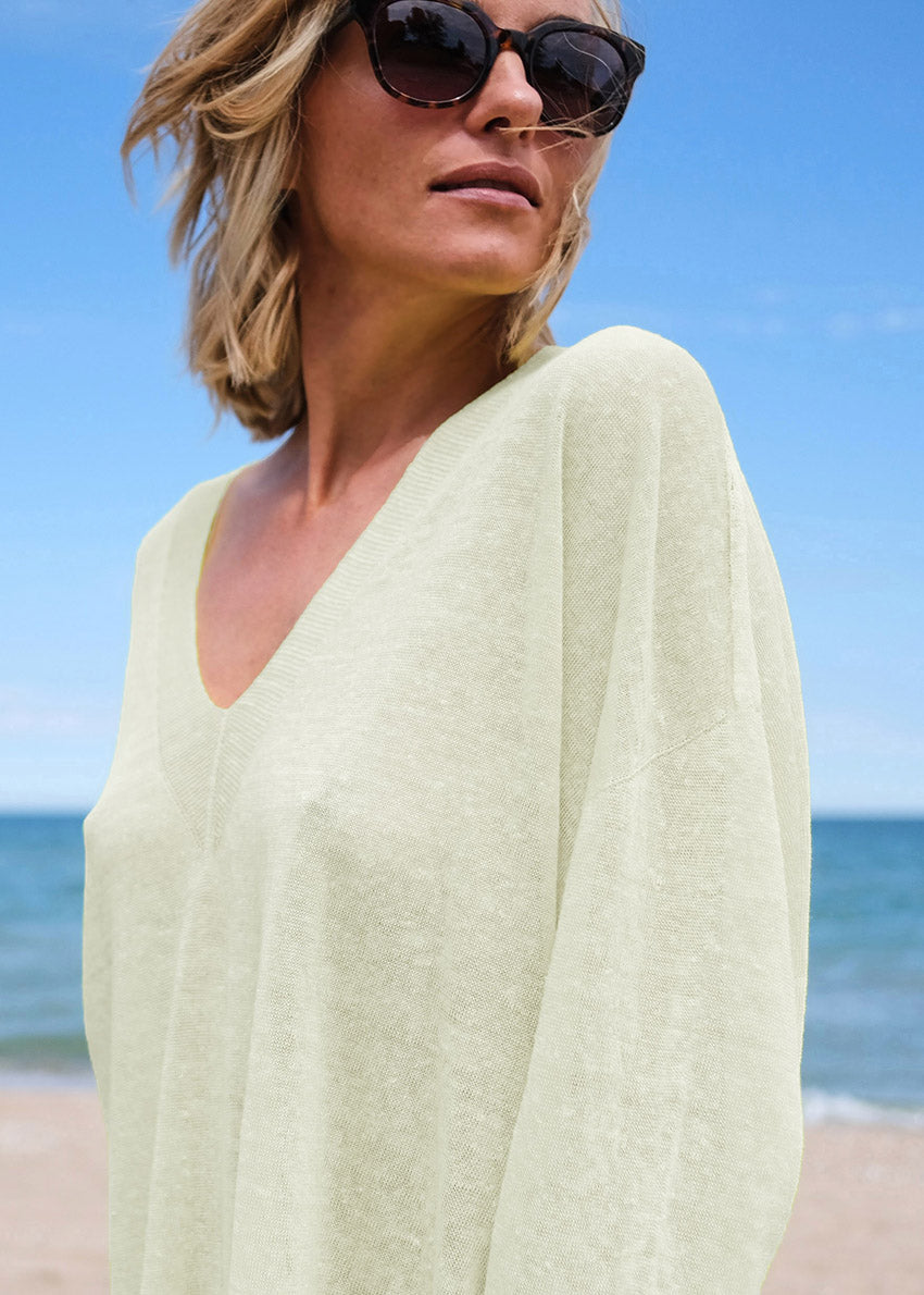 A true effortless essential, this graceful pullover is the perfect finish to any look casual style with deep V neck and dropped over the wrist sleeves, slits on the sides, longer on the back