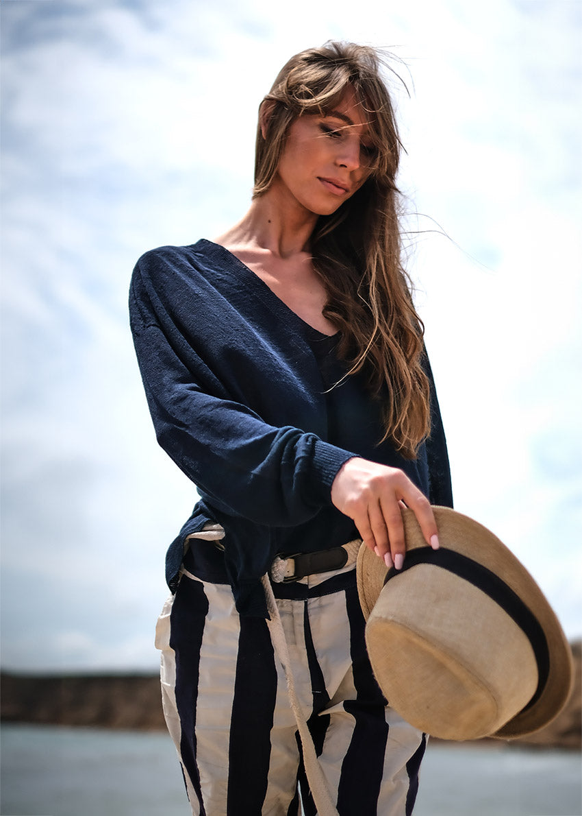 A true effortless essential, this graceful pullover is the perfect finish to any look casual style with deep V neck and dropped over the wrist sleeves, slits on the sides, longer on the back