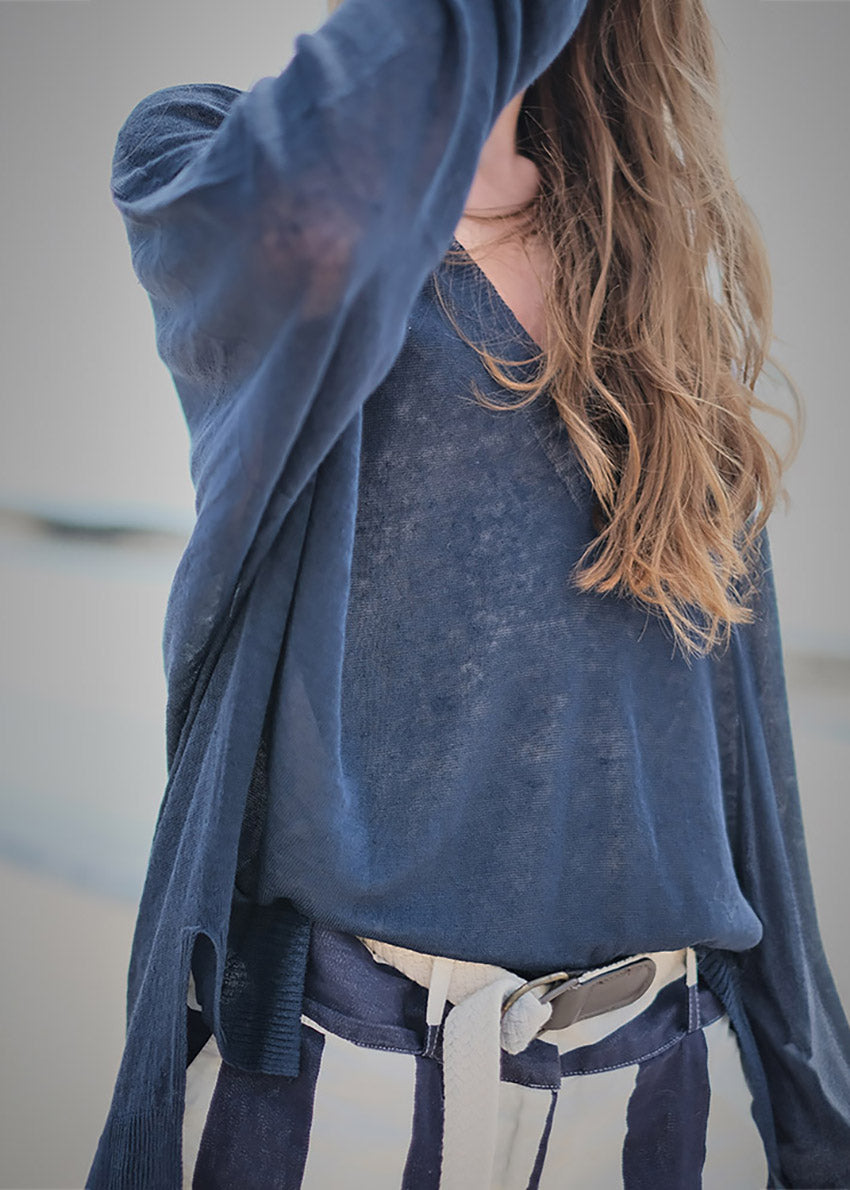 A true effortless essential, this graceful pullover is the perfect finish to any look casual style with deep V neck and dropped over the wrist sleeves, slits on the sides, longer on the back