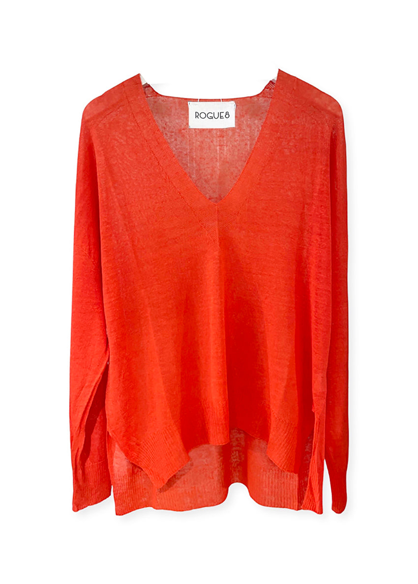 An orange, linen pullover sweater with a deep V-neck and dropped sleeves, with visible textured fabric.