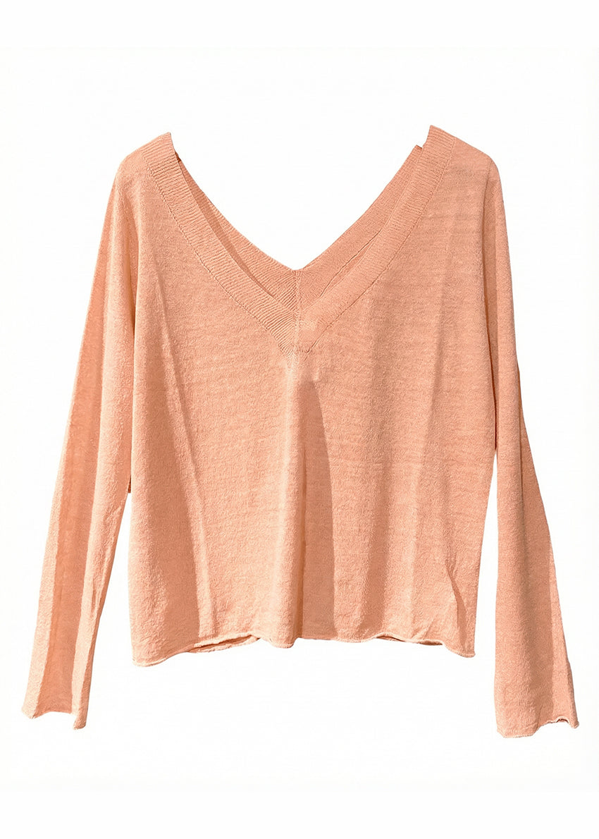 Pink long-sleeve top on a white background
