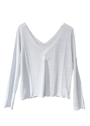 The sweater showcases a deep V-neckline at the front and back, adding a touch of sophistication to its minimalistic design.
