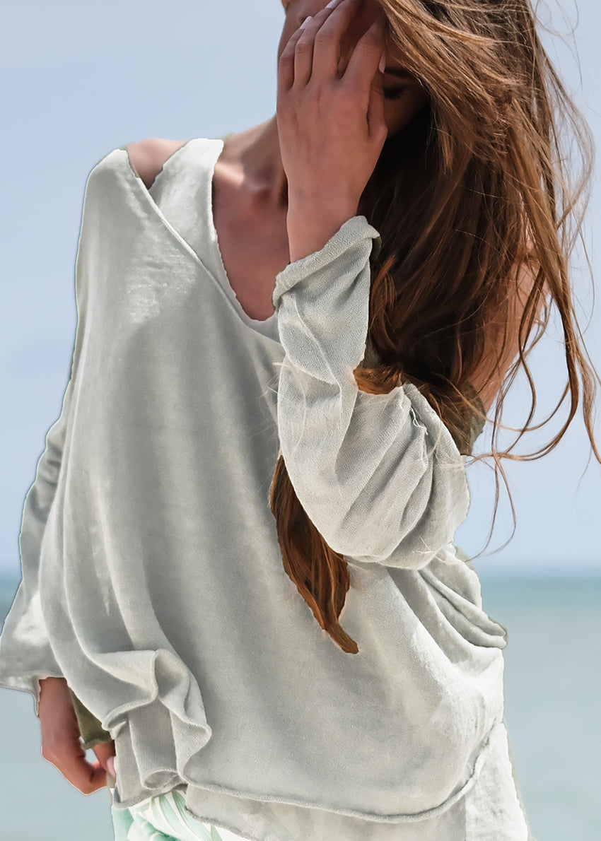 This stylishly funky yet timeless pullover features a medium length, deep V neckline on both sides, wide and relaxed fit, and long sleeves. It adds the perfect finishing touch to any casual look, and is effortlessly easy to pull on.