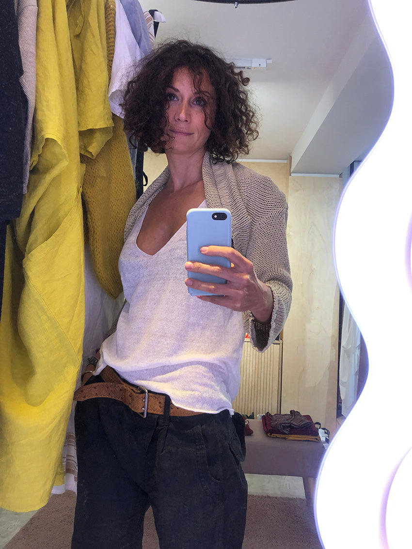 Be it your classic gal or a punk rock chick, this timeless top has got you covered. This versatile top will fulfill all your fashion cravings. A very simple large top, with a wide V front/ back, sleeveless, light and slight transparent knitted tank top