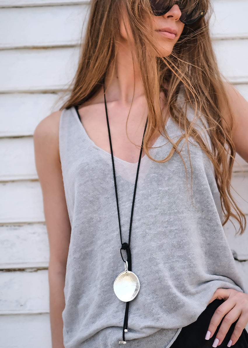 Be it your classic gal or a punk rock chick, this timeless top has got you covered. This versatile top will fulfill all your fashion cravings. A very simple large top, with a wide V front/ back, sleeveless, light and slight transparent knitted tank top