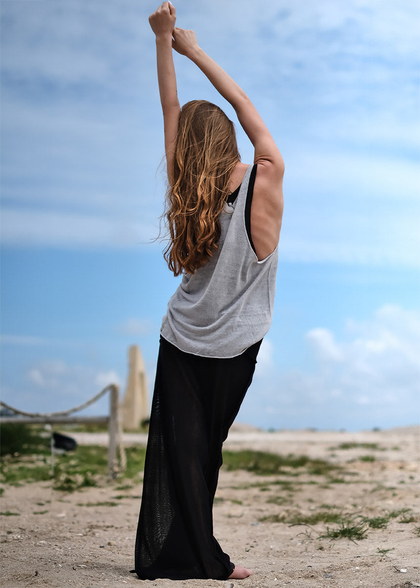 A beige, linen wheat top with a wide V-neck front and open halter back, branded with 'ROGUE' on the upper left side.