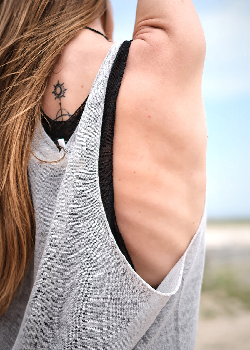 This top is like the sexy alter ego of the Miaou Top, complete with a playful halter back. With a wide V front neckline and open halter back, it's perfect for pairing with a matching bra or bustiere. Its lightweight and slightly sheer texture adds a touch of whimsy to any summer ensemble - ideal for layering and dreaming big!