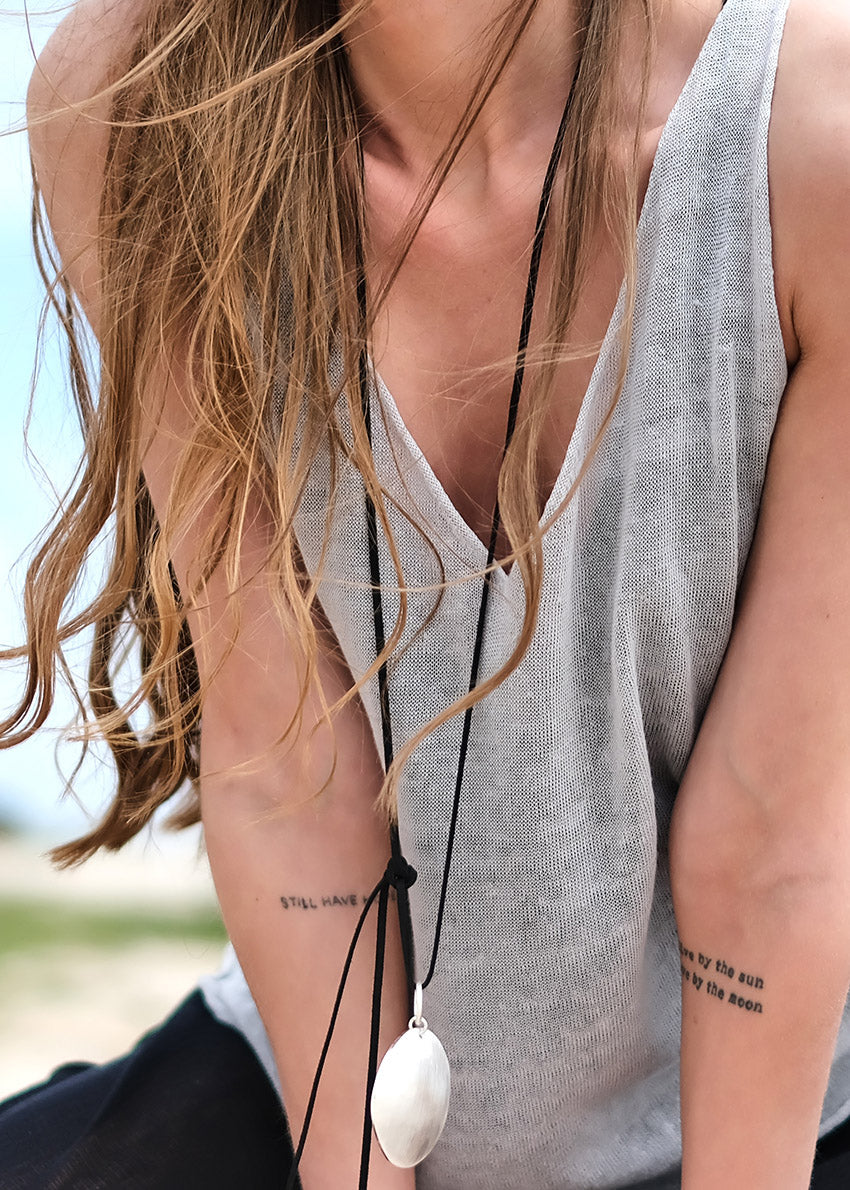 This top is like the sexy alter ego of the Miaou Top, complete with a playful halter back. With a wide V front neckline and open halter back, it's perfect for pairing with a matching bra or bustiere. Its lightweight and slightly sheer texture adds a touch of whimsy to any summer ensemble - ideal for layering and dreaming big!