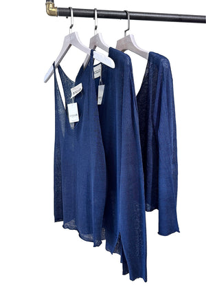 Three blue sleeveless tops hanging on white hangers, with a wide V-neckline and open halter back design.