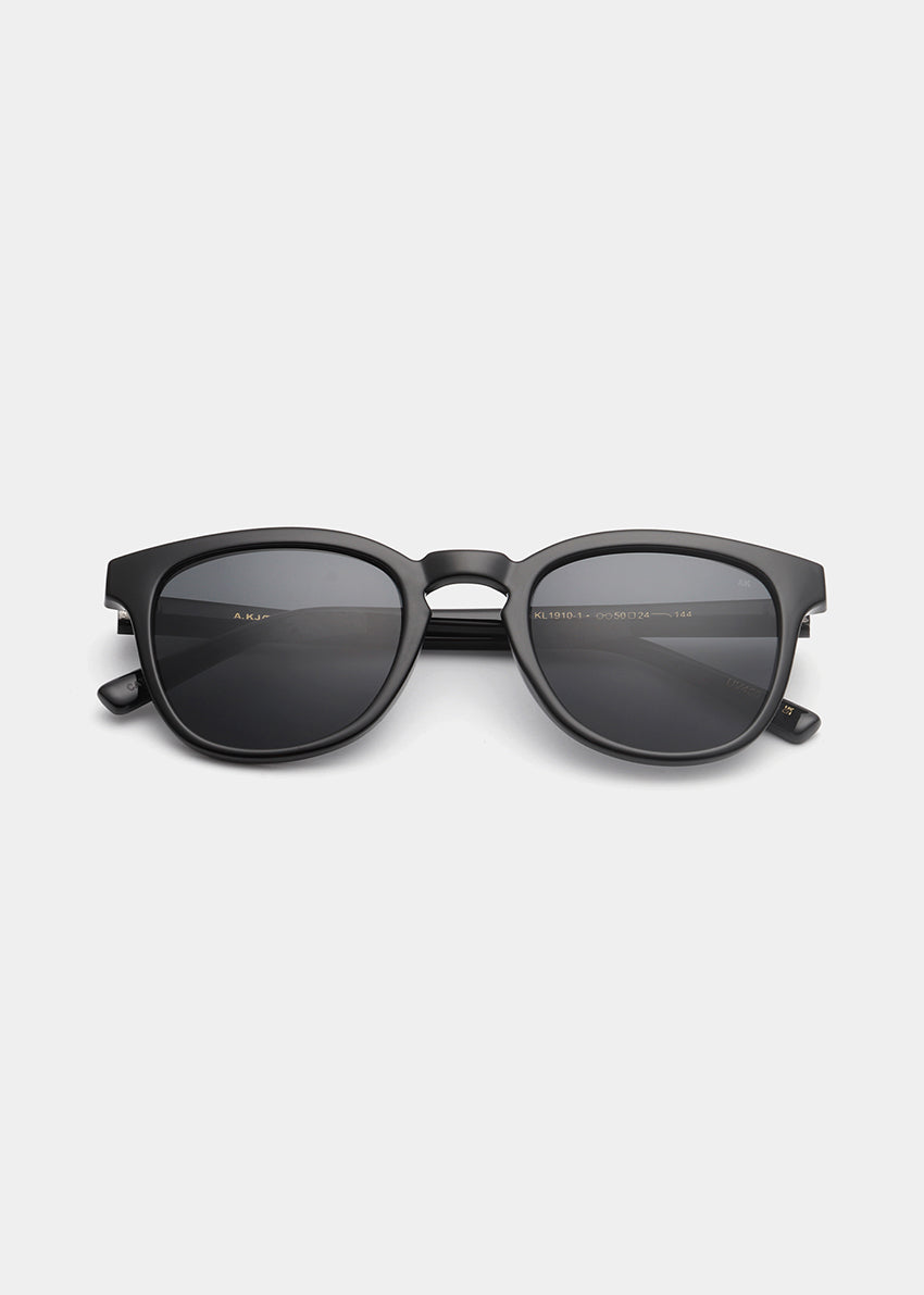 Black sunglasses with a brand logo on a light gray background
