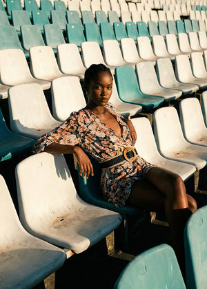 Woman sitting in a stadium with green and white seats