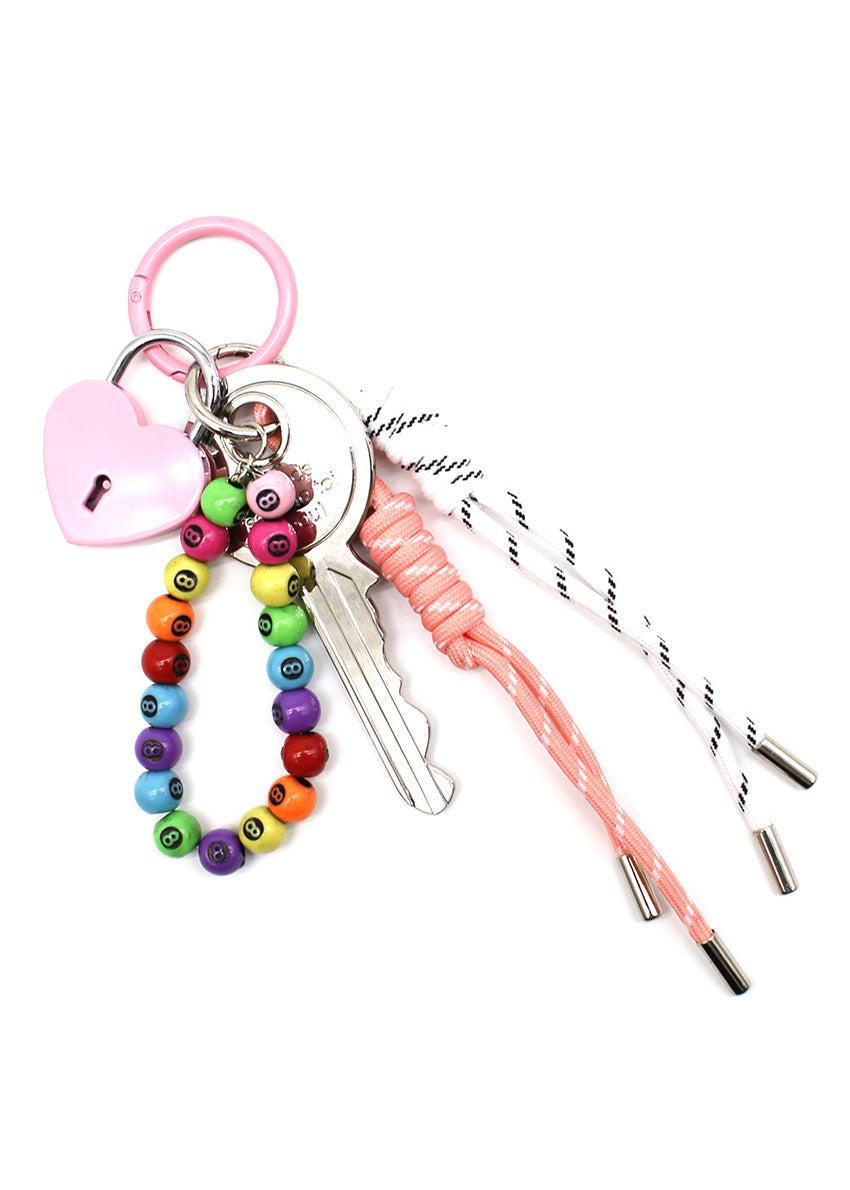 Keychain with colorful beads, pink bell, and straws on a white background