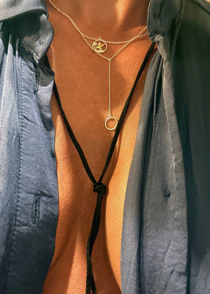 A fashionable necklace from the 'birds' collection, featuring a gold and silver color contrast with a bird-shaped pendant and a large circular charm.