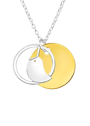 A fashionable necklace from the 'birds' collection, featuring a gold and silver color contrast with a bird-shaped pendant and a large circular charm.