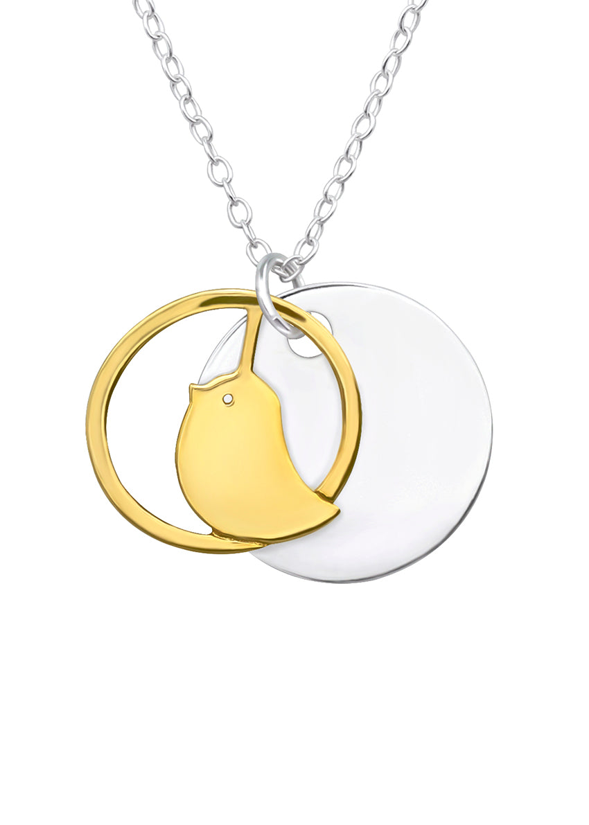 A fashionable necklace from the 'birds' collection, featuring a gold and silver color contrast with a bird-shaped pendant and a large circular charm.