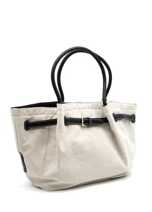 Light beige canvas tote bag with black leather handles and buckle accents. A spacious and durable design perfect for daily use