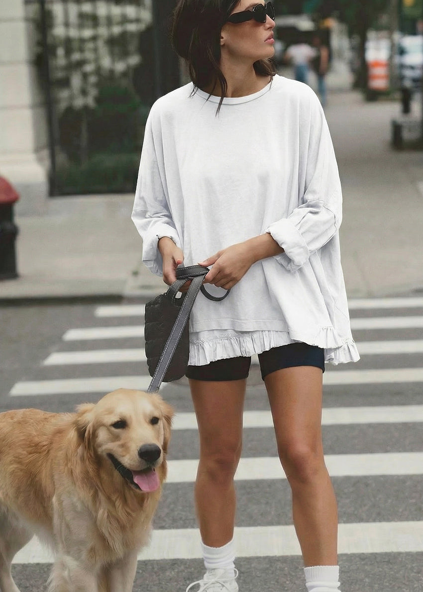Woman walking a dog on a leash in an urban setting