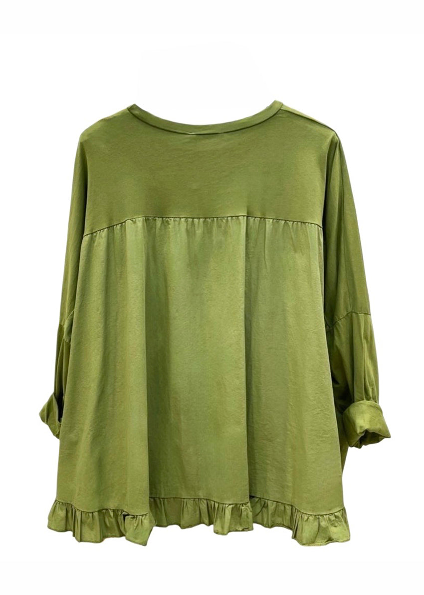 Green long-sleeve top with ruffled hem on a white background