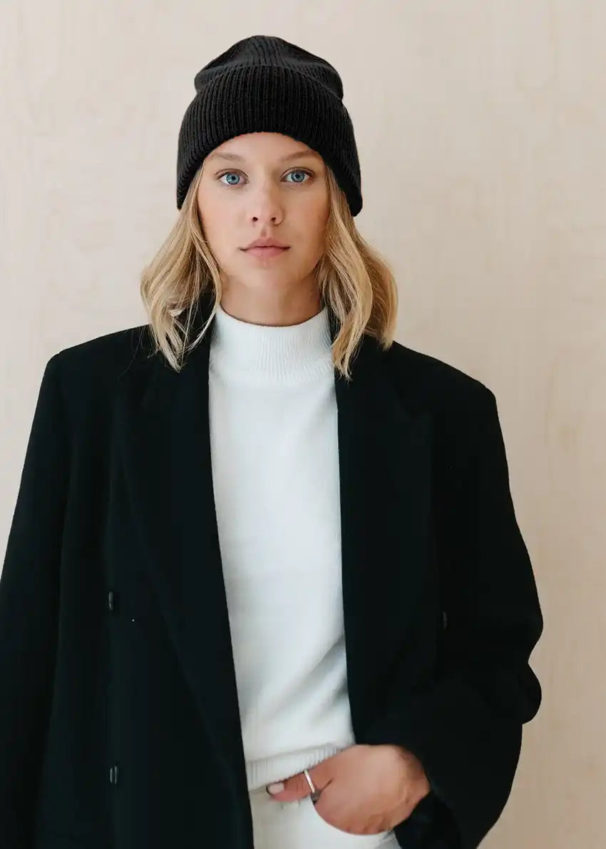 Unisex black beanie, artfully crafted from a luxurious melange of soft fibers. The color block design exudes effortless sophistication, providing endless styling possibilities.