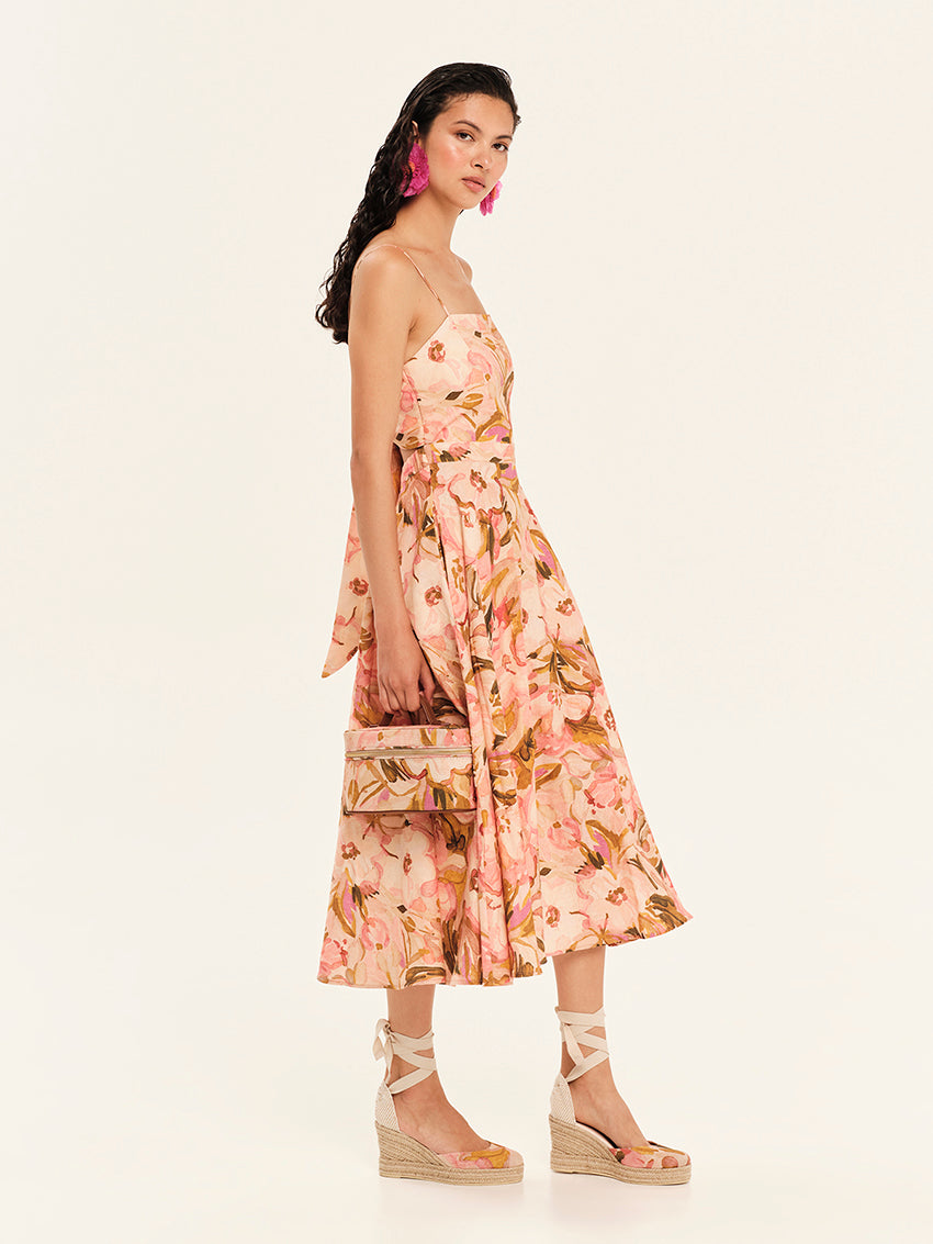 Woman wearing a floral strapless dress on a white background