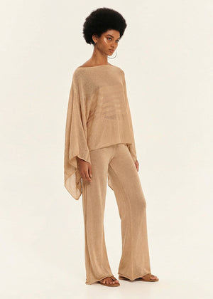 Woman wearing a beige outfit on a white background
