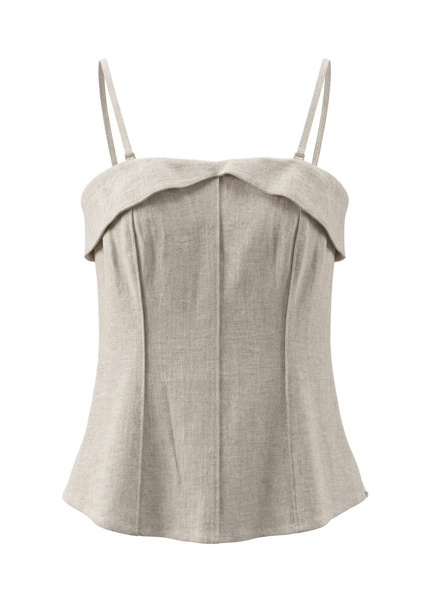Beige top with thin straps on a white background