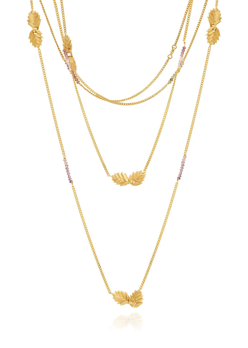 Gold layered necklace on a white background